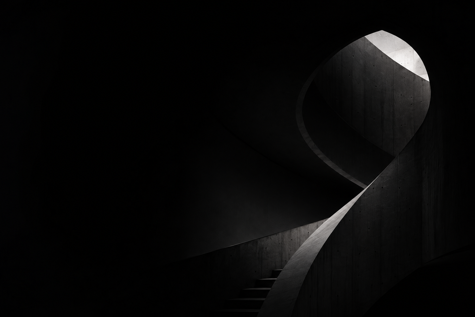 Spiral concrete staircase under a skylight